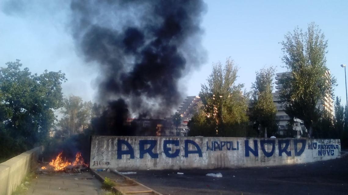 Rifiuti in fiamme a ridosso della villa comunale di Scampia
